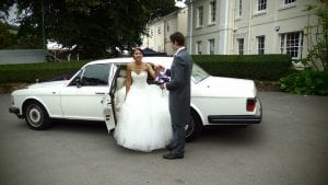 Niall helping Elle to step out of the Rolls-Royce Silver Spur