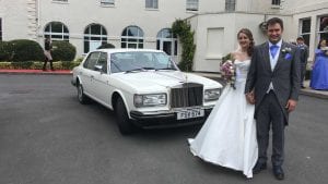 Oliver and Nadia with the Rolls-Royce Silver Spur wedding car in white