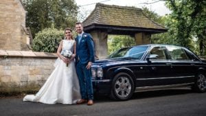 Newly-wed couple Amy and Jay with the Bentley Arnage wedding car in Blue