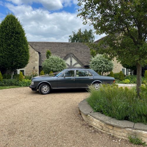 Grey Rolls Royce Flying Spur wedding car parked on the drive outside Hyde House