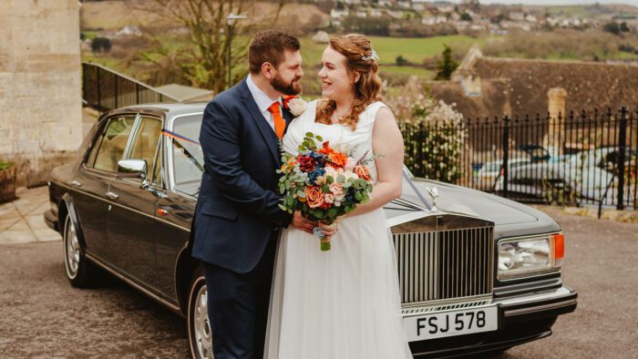 Newly-wed couple Claire and Dave with the Rolls-Royce wedding car in grey